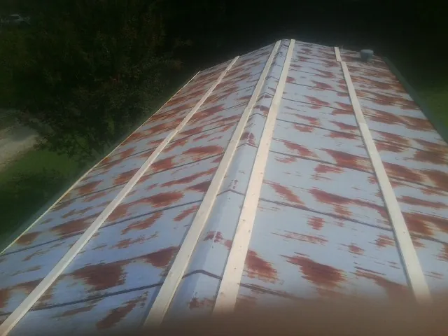 Rusted metal roof panels with new wood purlins before replacement — Storm Damage Roof Repair in Campbell Hall by Roofing Brothers